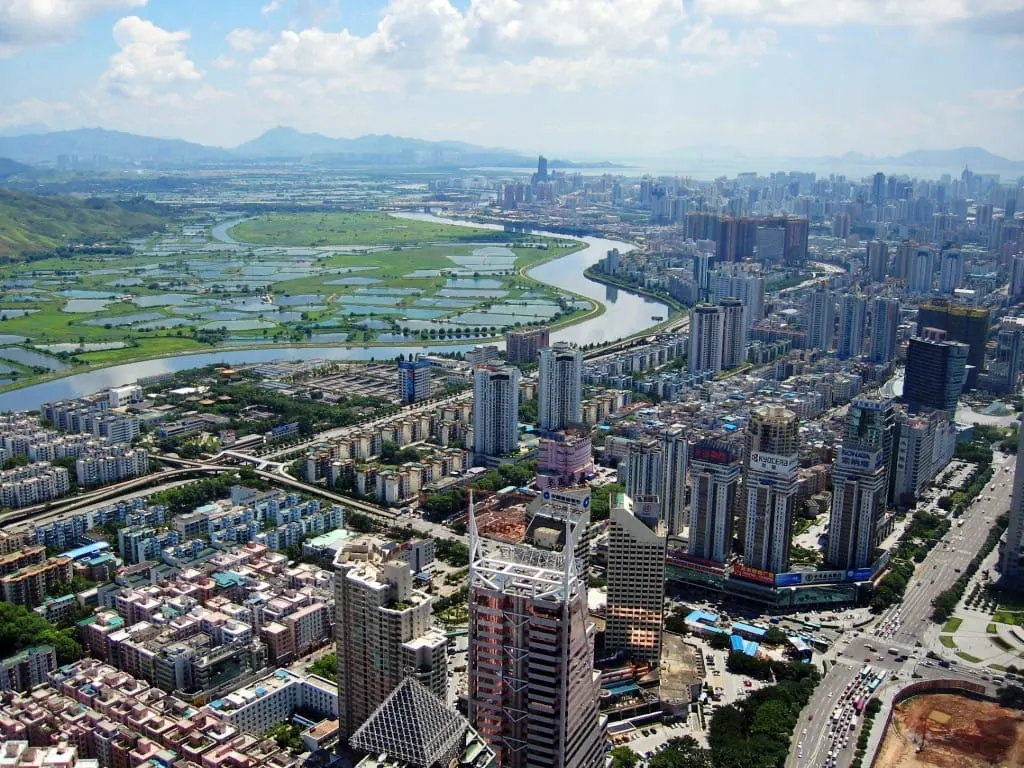 Aerial view of Shenzhen high-rises beside the river and wetlands