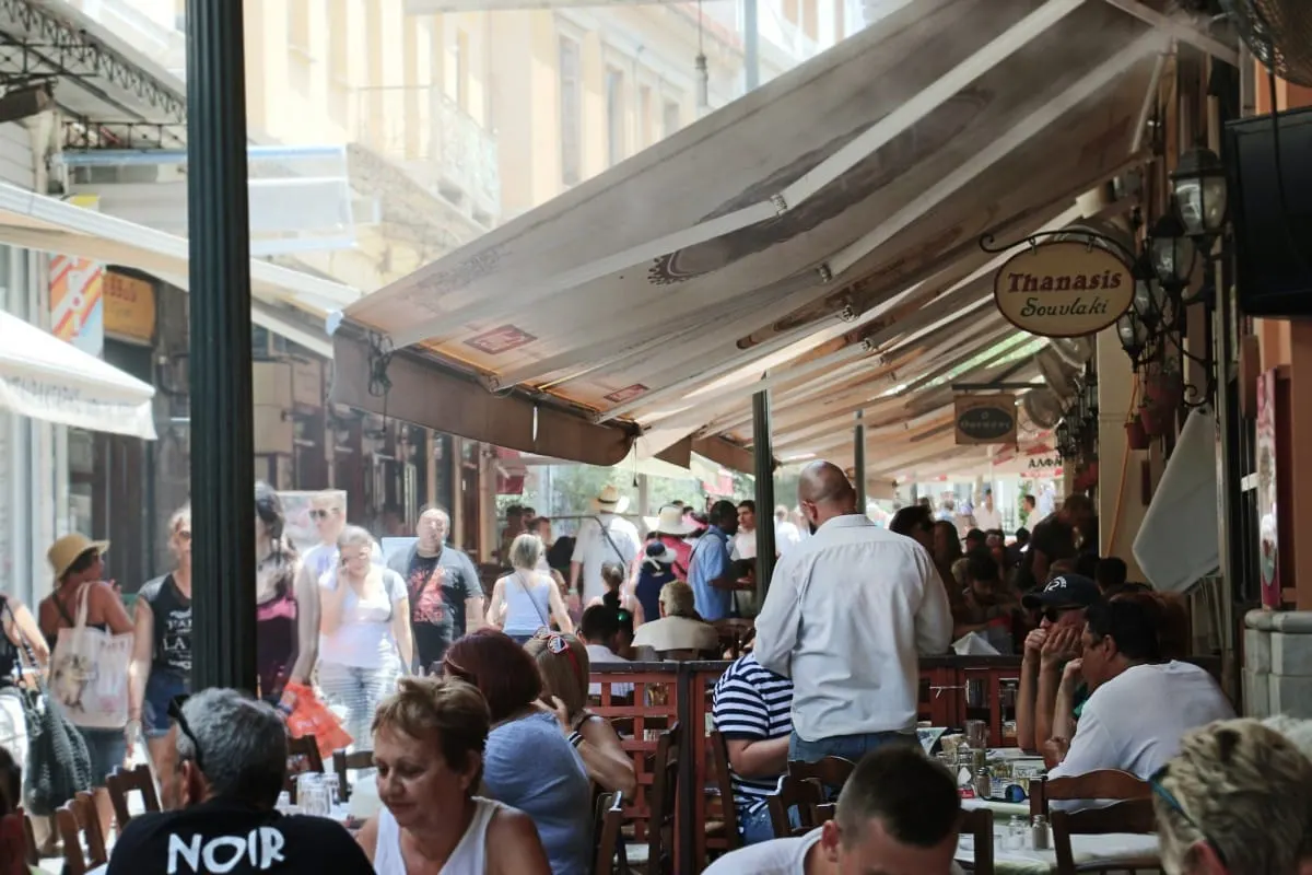 Crowded outdoor tables at Thanasis souvlaki restaurant, Athens