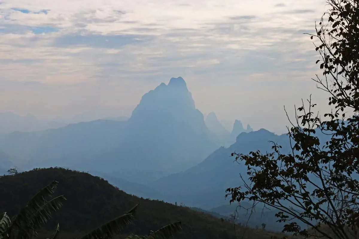 Hazy blue karst peaks seen from the road between Luang Prabang and Vientiane