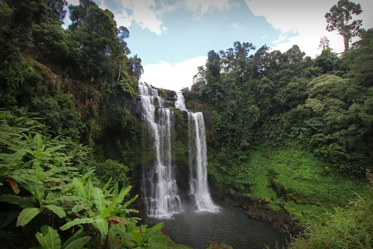 Tad Yuang waterfall framed by banana plants, Bolaven Plateau