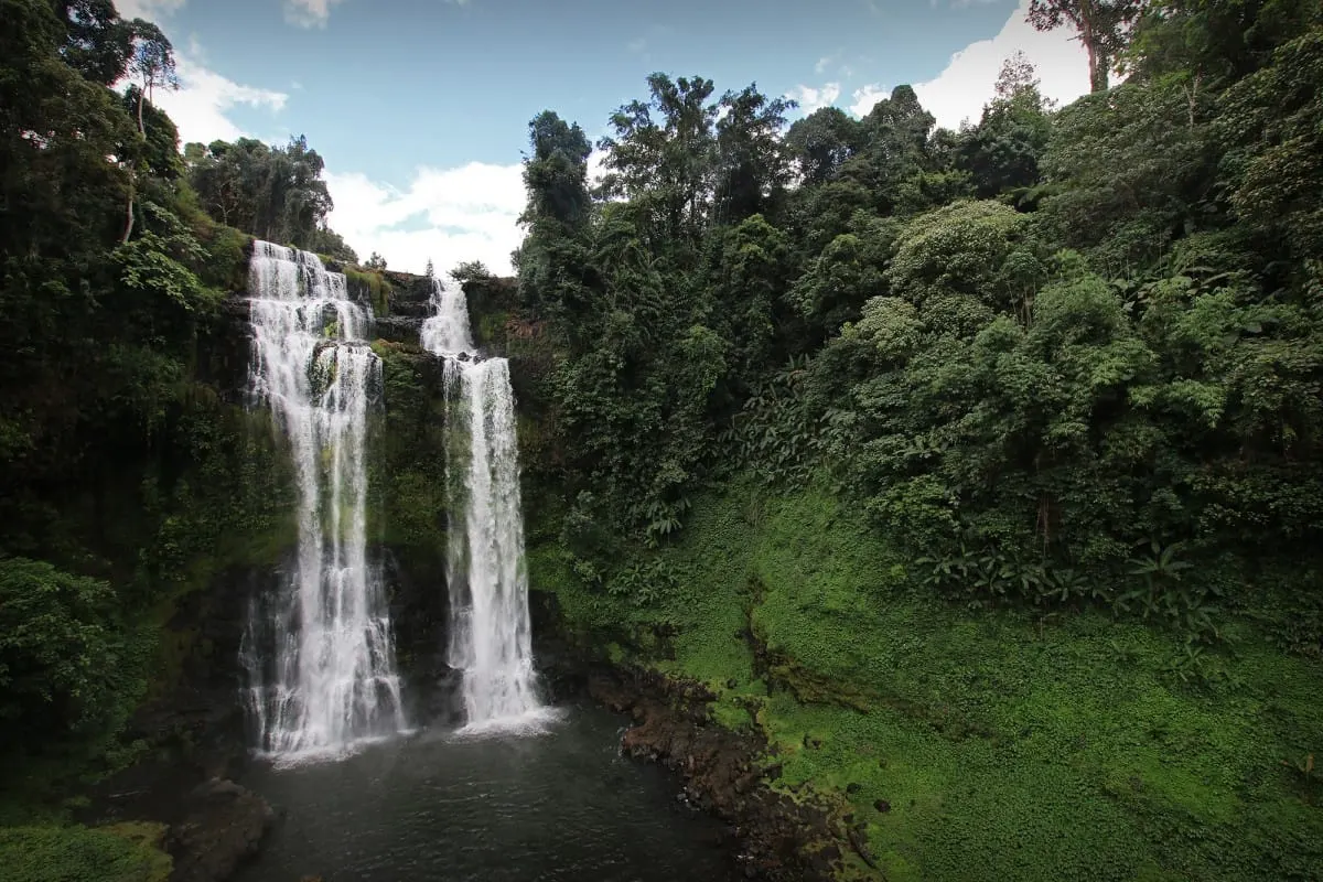 Twin cascades of Tad Yuang waterfall above a pool, Bolaven Plateau