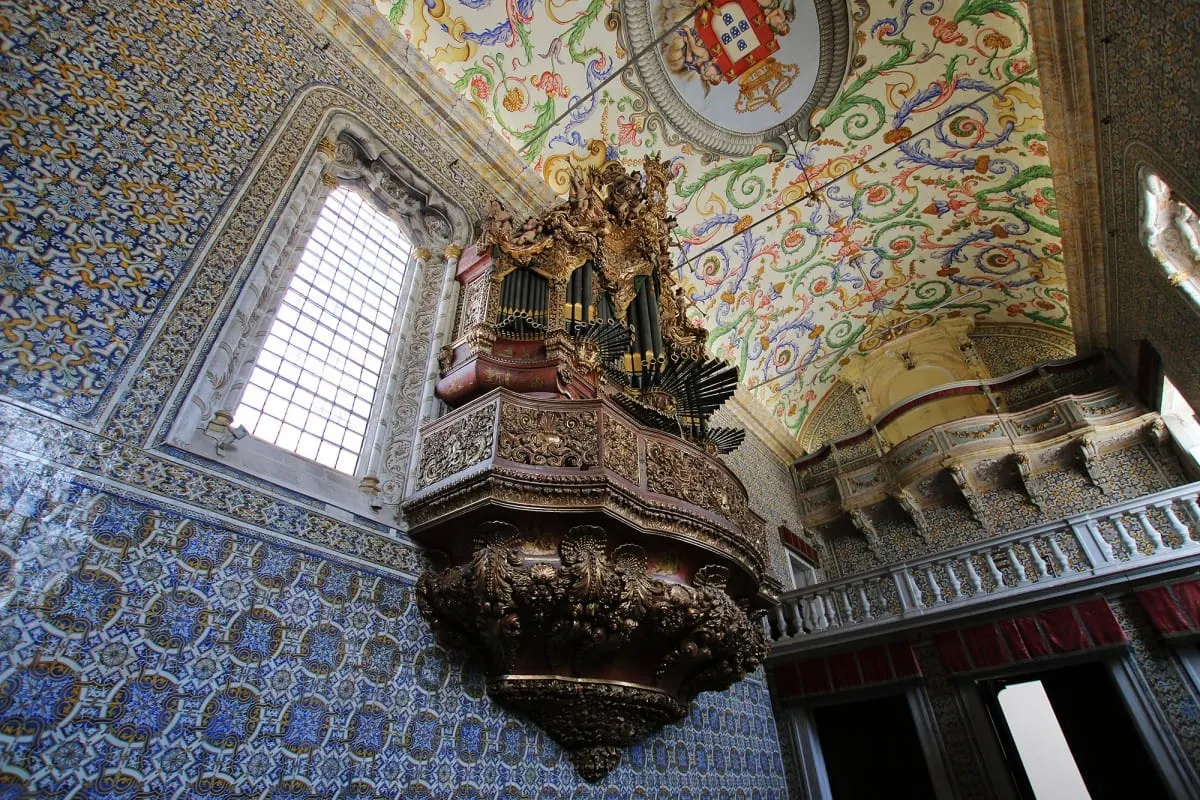 Gilded organ, painted ceiling and blue tile walls in the University of Coimbra chapel
