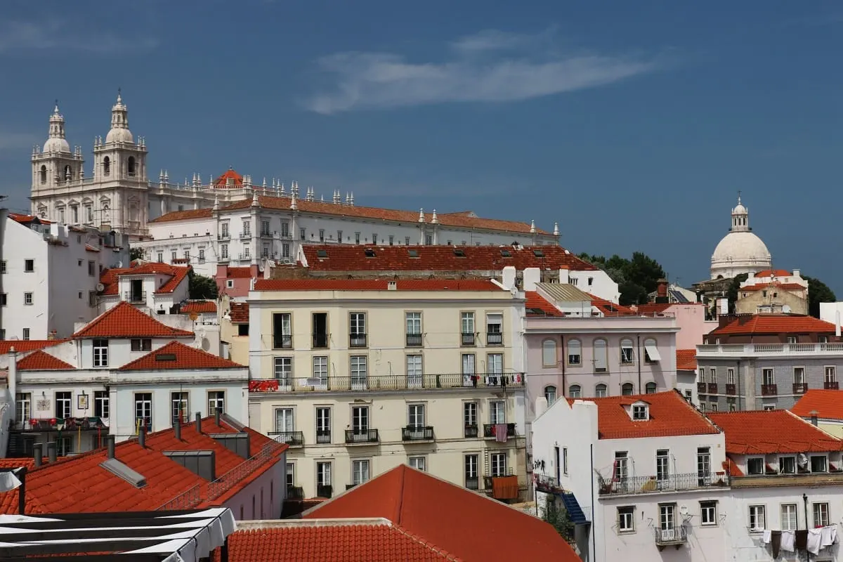 Red rooftops of Lisbon's old town below the Sao Vicente de Fora church and a dome