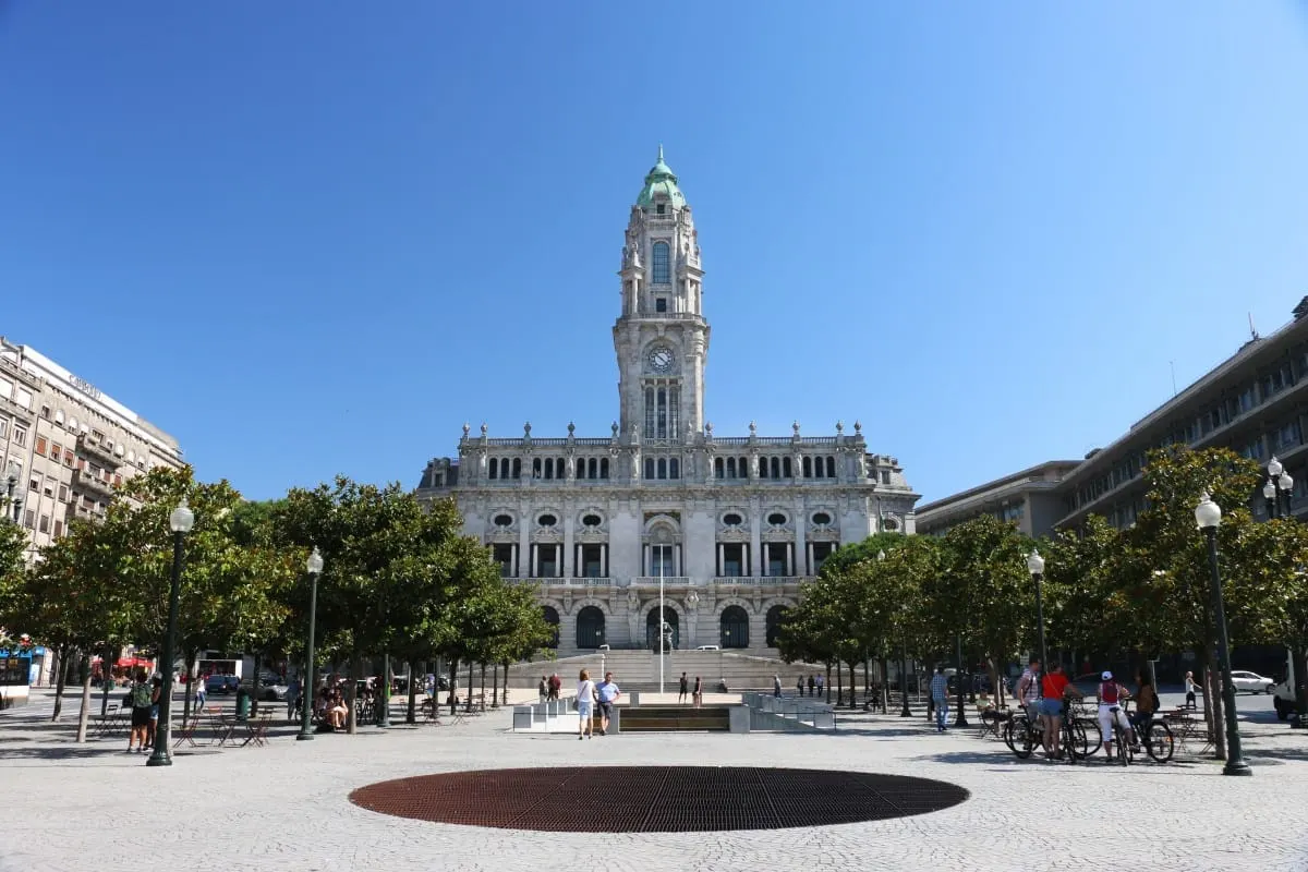 Porto's Camara Municipal city hall and clock tower above a tree-lined plaza