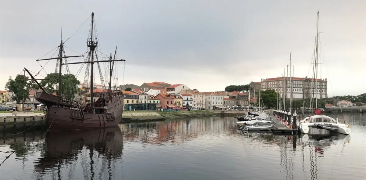 Replica sailing ship and yachts moored in the harbor at Vila do Conde