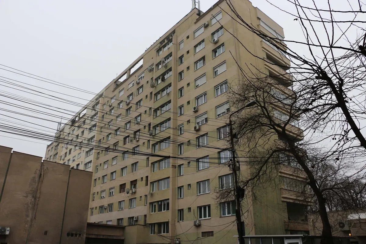 Communist-era apartment block behind tangled power lines