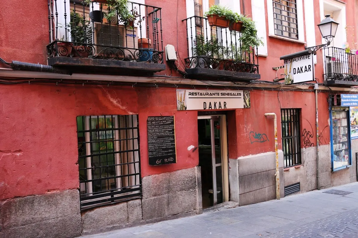 Red facade of Restaurante Dakar, a Senegalese restaurant in Lavapies, Madrid