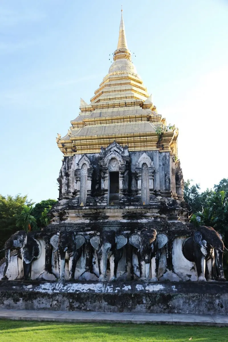 Gold-topped chedi on a base of elephant sculptures at a Chiang Mai temple
