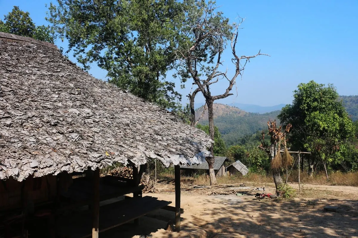 Leaf-thatched hut and simple houses in a hilltribe village near Mae Wang.